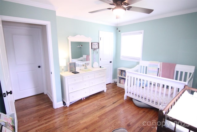 201 Mitchell St, Belmont, NC 28012 - bedroom featuring baseboards, ornamental molding, a crib, and light wood-style flooring