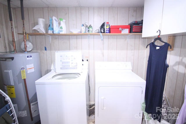 201 Mitchell St, Belmont, NC 28012 - laundry area featuring water heater, wooden walls, washing machine and clothes dryer, and cabinet space