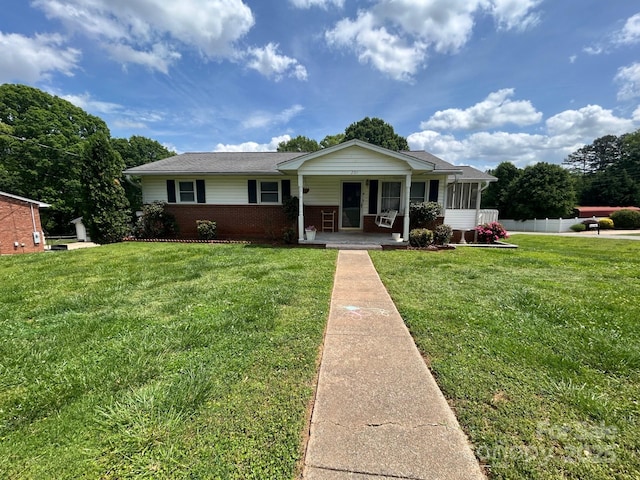 201 Mitchell St, Belmont, NC 28012 - view of front of home with brick siding, a porch, fence, and a front yard