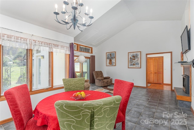 196 Timberline Dr, Maggie Valley, NC 28751 - dining area with a chandelier, high vaulted ceiling, and a fireplace with raised hearth