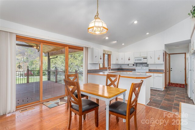 196 Timberline Dr, Maggie Valley, NC 28751 - dining space featuring visible vents, dark wood-style flooring, recessed lighting, vaulted ceiling, and a notable chandelier