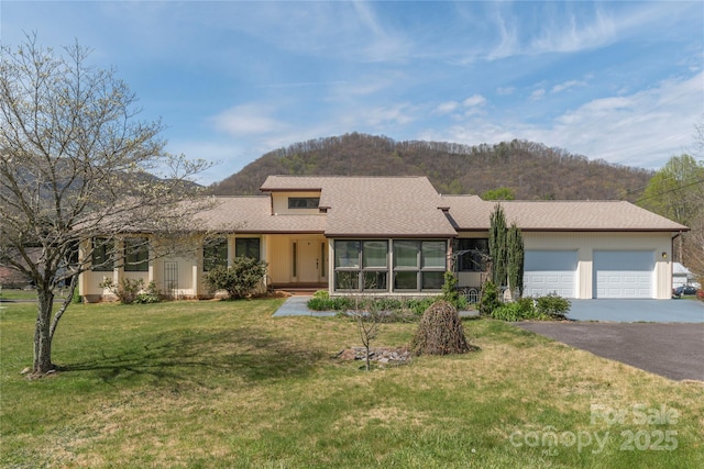 196 Timberline Dr, Maggie Valley, NC 28751 - view of front facade with a front yard, aphalt driveway, a mountain view, and a garage