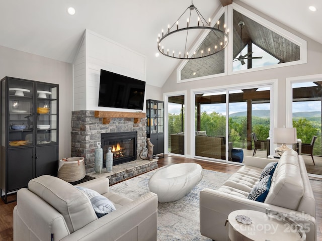 636 Crystal Heights Dr, Hendersonville, NC 28739 - living room featuring a fireplace, wood finished floors, high vaulted ceiling, a chandelier, and a ceiling fan