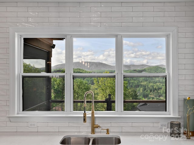 636 Crystal Heights Dr, Hendersonville, NC 28739 - kitchen view of a mountain view, a sink, and light countertops