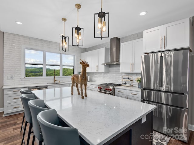 636 Crystal Heights Dr, Hendersonville, NC 28739 - kitchen with stainless steel appliances, wall chimney range hood, a sink, backsplash, and dark wood finished floors
