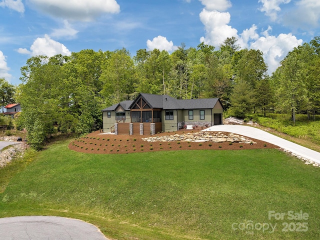 636 Crystal Heights Dr, Hendersonville, NC 28739 - view of front of home featuring concrete driveway, a front lawn, and an attached garage