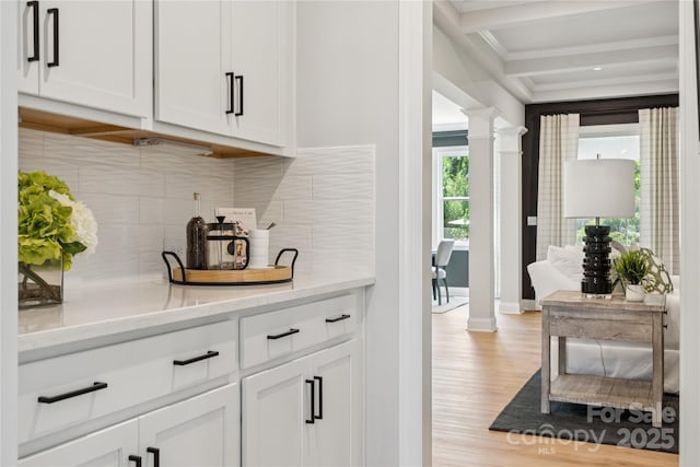 424 Balboa St, Matthews, NC 28104 - bar area with decorative columns, light wood-style flooring, tasteful backsplash, and crown molding