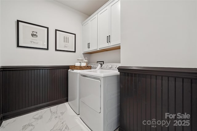 424 Balboa St, Matthews, NC 28104 - laundry room featuring independent washer and dryer, light marble finish floors, cabinet space, and a wainscoted wall