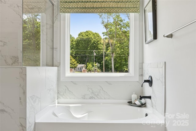 424 Balboa St, Matthews, NC 28104 - bathroom featuring a bath and healthy amount of natural light