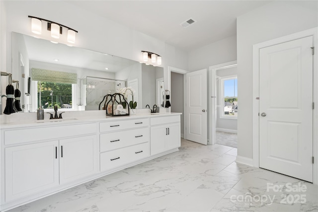 424 Balboa St, Matthews, NC 28104 - bathroom with double vanity, marble look tiles, and a marble finish shower