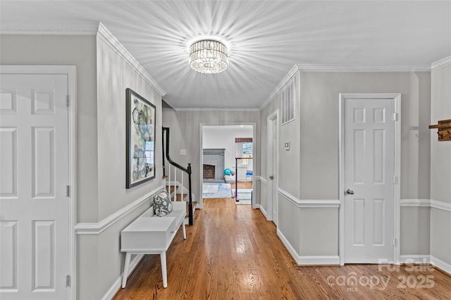 2418 Ainsdale Rd, Charlotte, NC 28226 - hallway with wood finished floors, baseboards, a chandelier, and crown molding