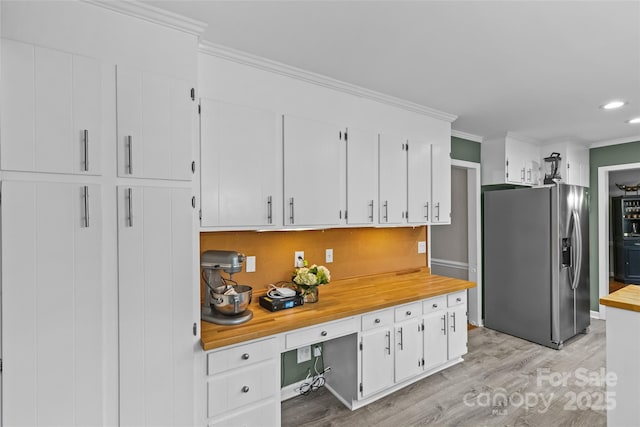 2418 Ainsdale Rd, Charlotte, NC 28226 - kitchen with stainless steel fridge with ice dispenser, light wood finished floors, crown molding, white cabinets, and butcher block counters