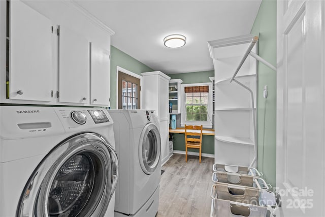 2418 Ainsdale Rd, Charlotte, NC 28226 - washroom with washer and dryer, cabinet space, and light wood-type flooring