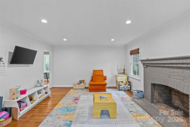 2418 Ainsdale Rd, Charlotte, NC 28226 - living area featuring crown molding, plenty of natural light, a brick fireplace, wood finished floors, and recessed lighting