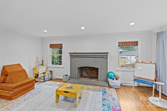 2418 Ainsdale Rd, Charlotte, NC 28226 - living area featuring ornamental molding, wood finished floors, a fireplace, recessed lighting, and baseboards