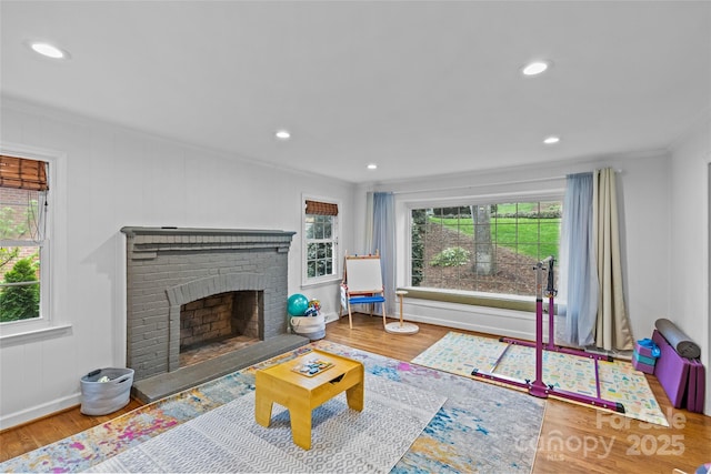 2418 Ainsdale Rd, Charlotte, NC 28226 - living room featuring ornamental molding, wood finished floors, a brick fireplace, recessed lighting, and baseboards