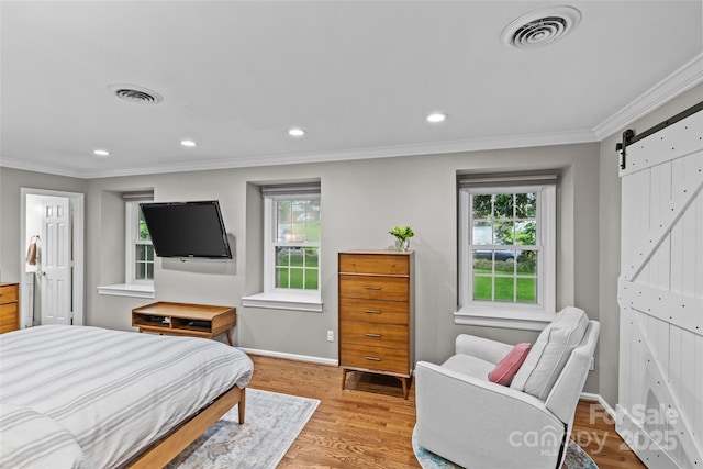 2418 Ainsdale Rd, Charlotte, NC 28226 - bedroom with a barn door, ornamental molding, light wood-type flooring, baseboards, and recessed lighting