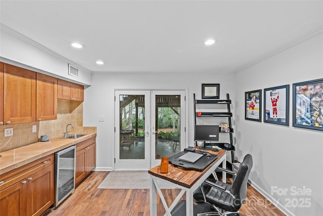 2418 Ainsdale Rd, Charlotte, NC 28226 - kitchen featuring beverage cooler, french doors, a sink, light wood-style floors, and recessed lighting