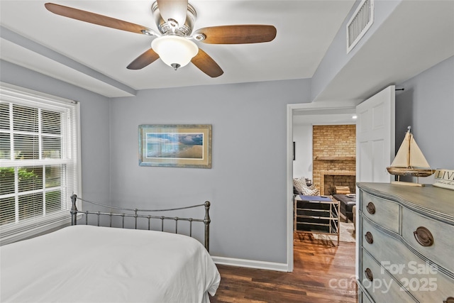 2418 Ainsdale Rd, Charlotte, NC 28226 - bedroom with dark wood-style floors, baseboards, a fireplace, and a ceiling fan
