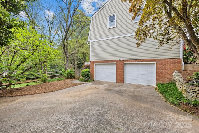 2418 Ainsdale Rd, Charlotte, NC 28226 - view of home's exterior featuring a garage, concrete driveway, and brick siding