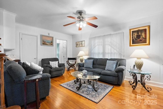 living room featuring crown molding, ceiling fan, and wood finished floors