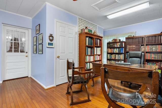 office featuring crown molding, baseboards, and light wood-style floors