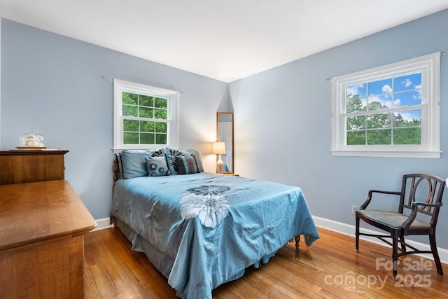 bedroom featuring baseboards and hardwood / wood-style floors