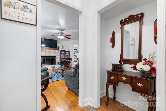 corridor with baseboards and wood finished floors