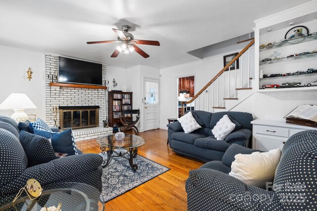 1287 Queensgate St, Gastonia, NC 28054 - living room with a ceiling fan, wood finished floors, stairs, and a fireplace