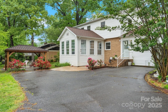 1287 Queensgate St, Gastonia, NC 28054 - view of front of house with a gazebo, entry steps, brick siding, and roof with shingles