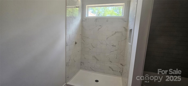 full bathroom with tiled shower