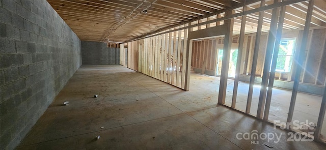 misc room featuring concrete block wall