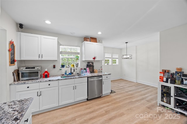 1009 Rainbow Cir, Catawba, SC 29704 - kitchen featuring dishwasher, a sink, light wood finished floors, white cabinetry, and light stone countertops