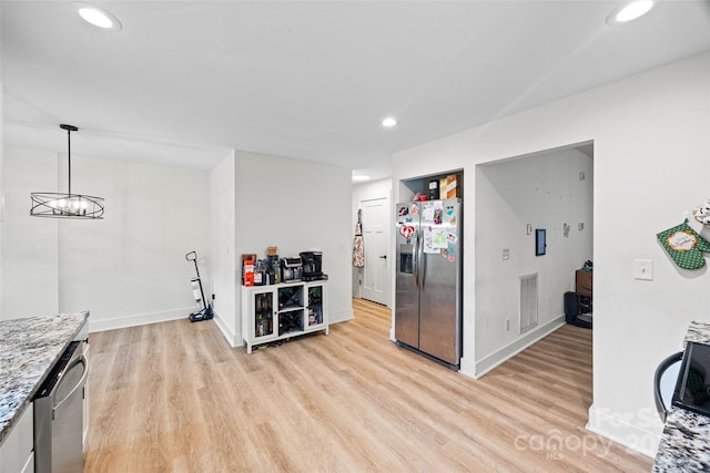 1009 Rainbow Cir, Catawba, SC 29704 - kitchen with appliances with stainless steel finishes, light wood finished floors, baseboards, recessed lighting, and light stone counters