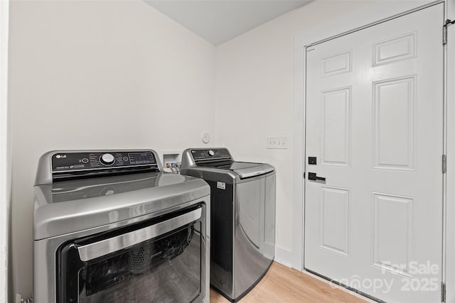 1009 Rainbow Cir, Catawba, SC 29704 - laundry area with washing machine and dryer and light wood-style flooring