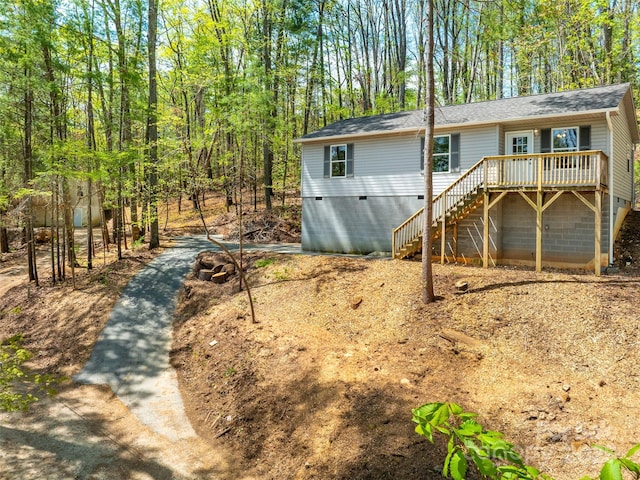 back of property featuring stairs, roof with shingles, crawl space, and a deck