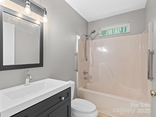 full bathroom featuring vanity, bathtub / shower combination, and toilet
