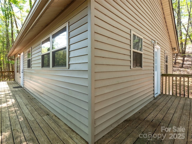 view of property exterior with a deck