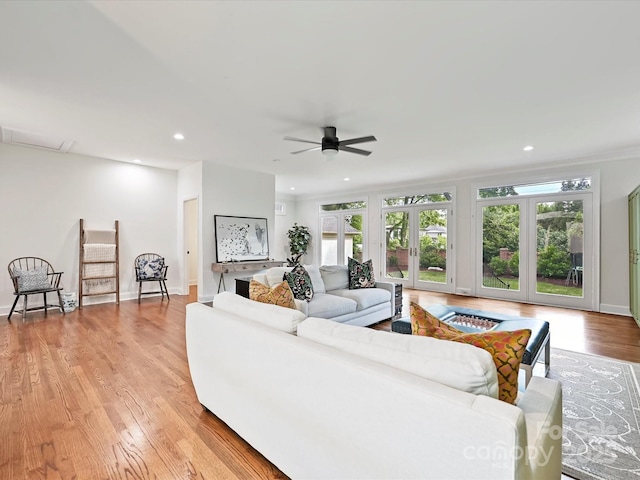 living area featuring recessed lighting, ceiling fan, a healthy amount of sunlight, and light wood finished floors
