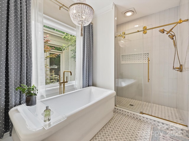 full bathroom with a freestanding tub, a notable chandelier, a shower stall, and tile patterned floors