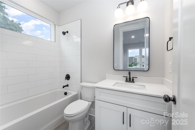 bathroom with vanity, toilet, and shower / washtub combination