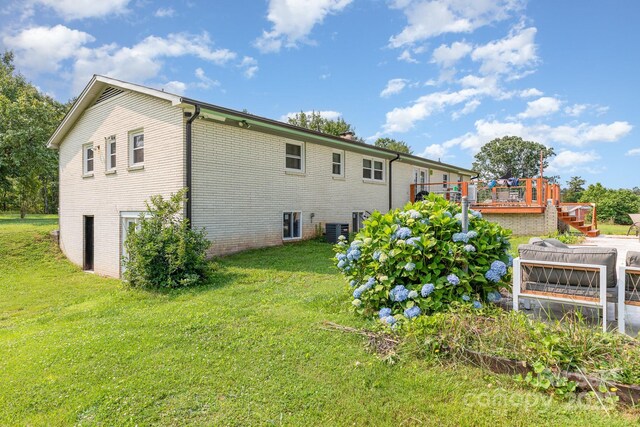 3603 Ken Mcentire Rd, Lawndale, NC 28090 - rear view of house featuring a yard, central AC unit, a deck, and brick siding