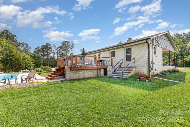 3603 Ken Mcentire Rd, Lawndale, NC 28090 - back of property with stairs, a deck, a lawn, a chimney, and an outdoor pool
