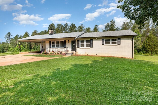 3603 Ken Mcentire Rd, Lawndale, NC 28090 - single story home with covered porch, brick siding, a front lawn, an attached carport, and a chimney