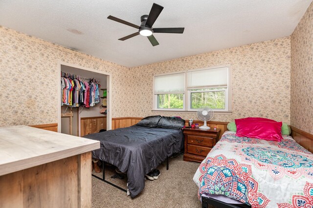 3603 Ken Mcentire Rd, Lawndale, NC 28090 - bedroom featuring wallpapered walls, wainscoting, a textured ceiling, a ceiling fan, and carpet