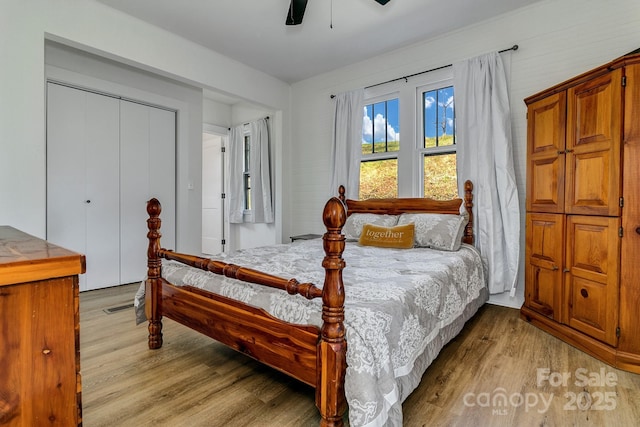 bedroom with light wood-style floors, a closet, a ceiling fan, and visible vents