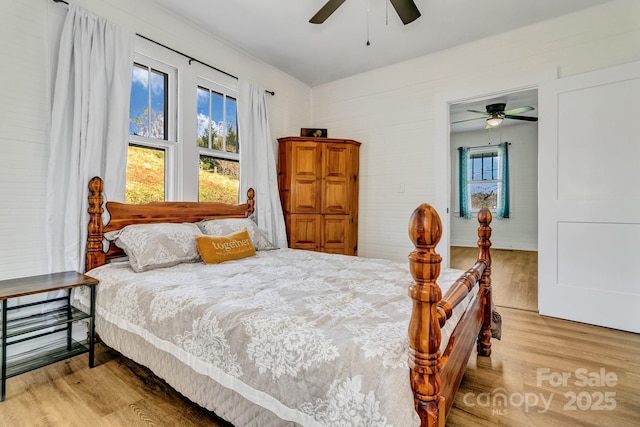 bedroom featuring a ceiling fan and light wood-type flooring