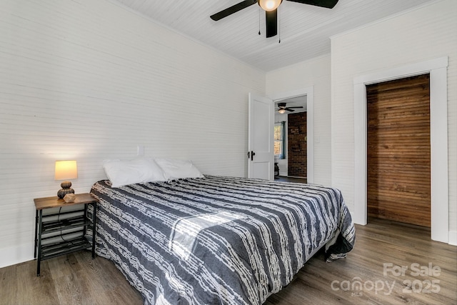 bedroom with a ceiling fan and wood finished floors