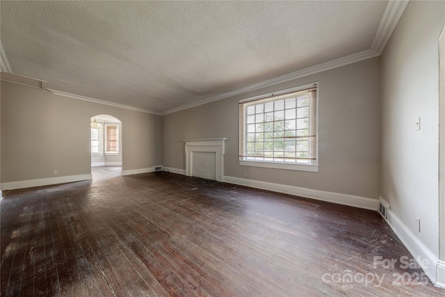 unfurnished living room with arched walkways, plenty of natural light, and dark wood-style floors