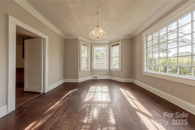 unfurnished dining area featuring a textured ceiling, dark wood finished floors, baseboards, visible vents, and a chandelier